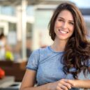 Big bright white smile headshot with a beautiful brunette woman sincere happy cheerful positive expression